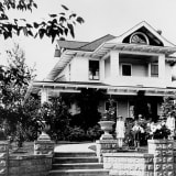 Exterior view of the Ash Residence, circa 1920, showcasing its architecture.