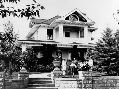 Exterior view of the Ash Residence, circa 1920, showcasing its architecture.