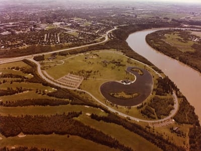 Aerial view of Edmonton’s river valley with the North Saskatchewan River curving past parkland and roads.